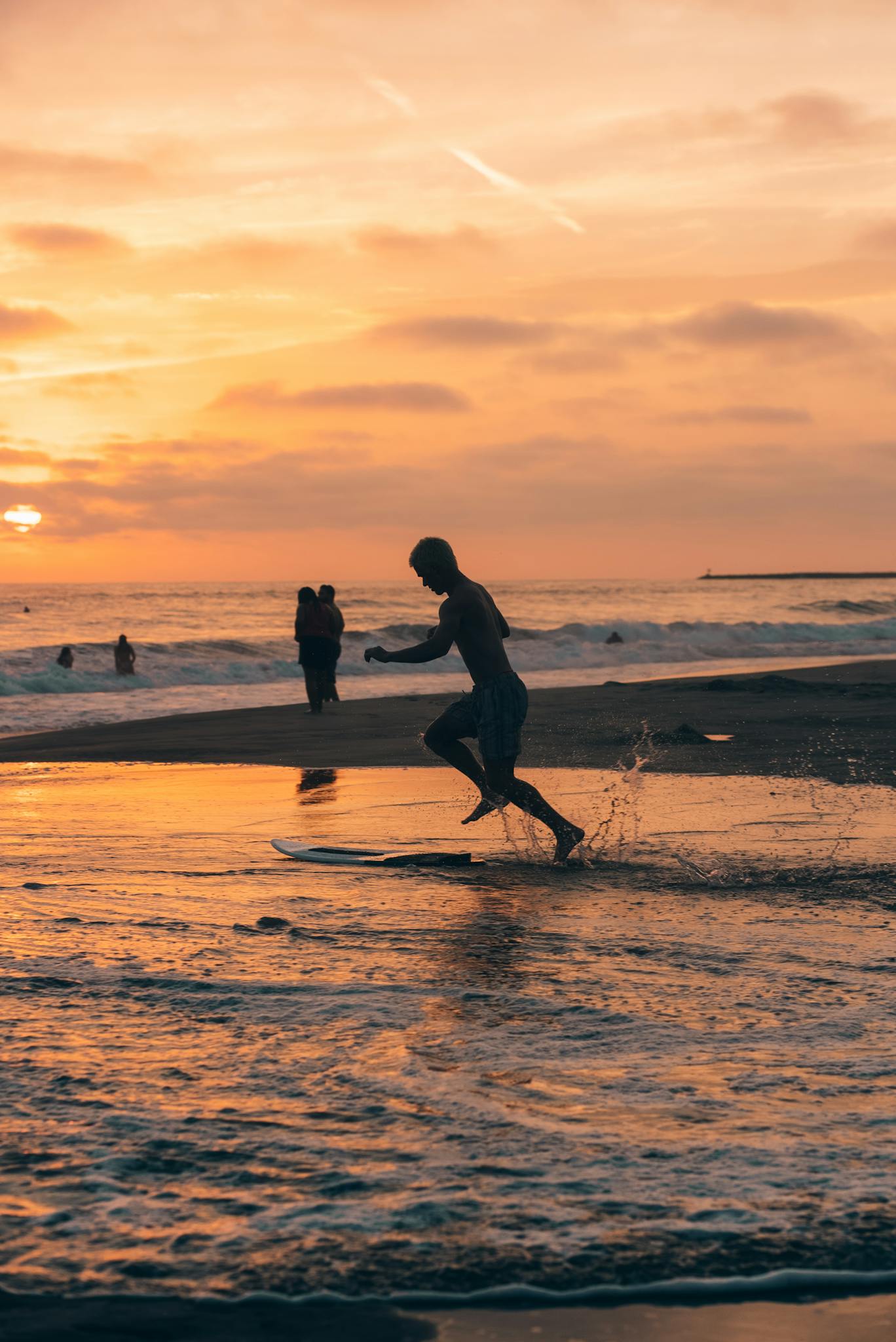 Silhouette of a surfer at sunset on a scenic beach, capturing the serene beauty and vibrant colors.