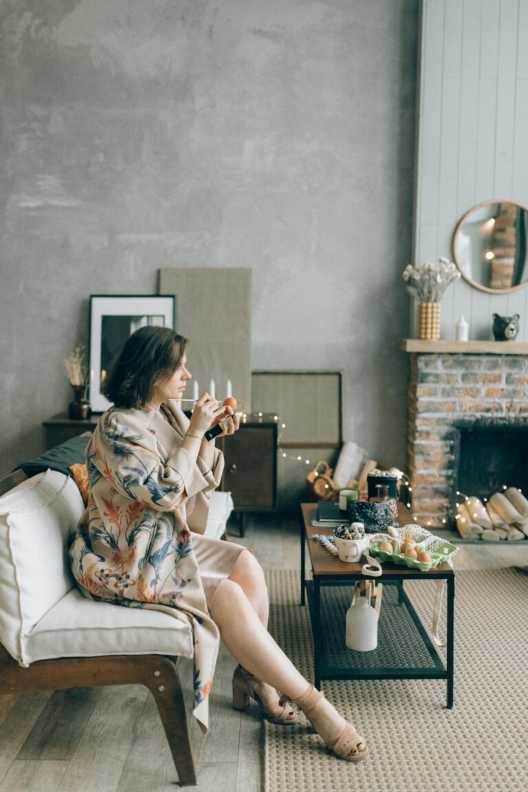 A serene indoor scene featuring a woman enjoying a peaceful moment with a warm drink in a stylishly decorated room.